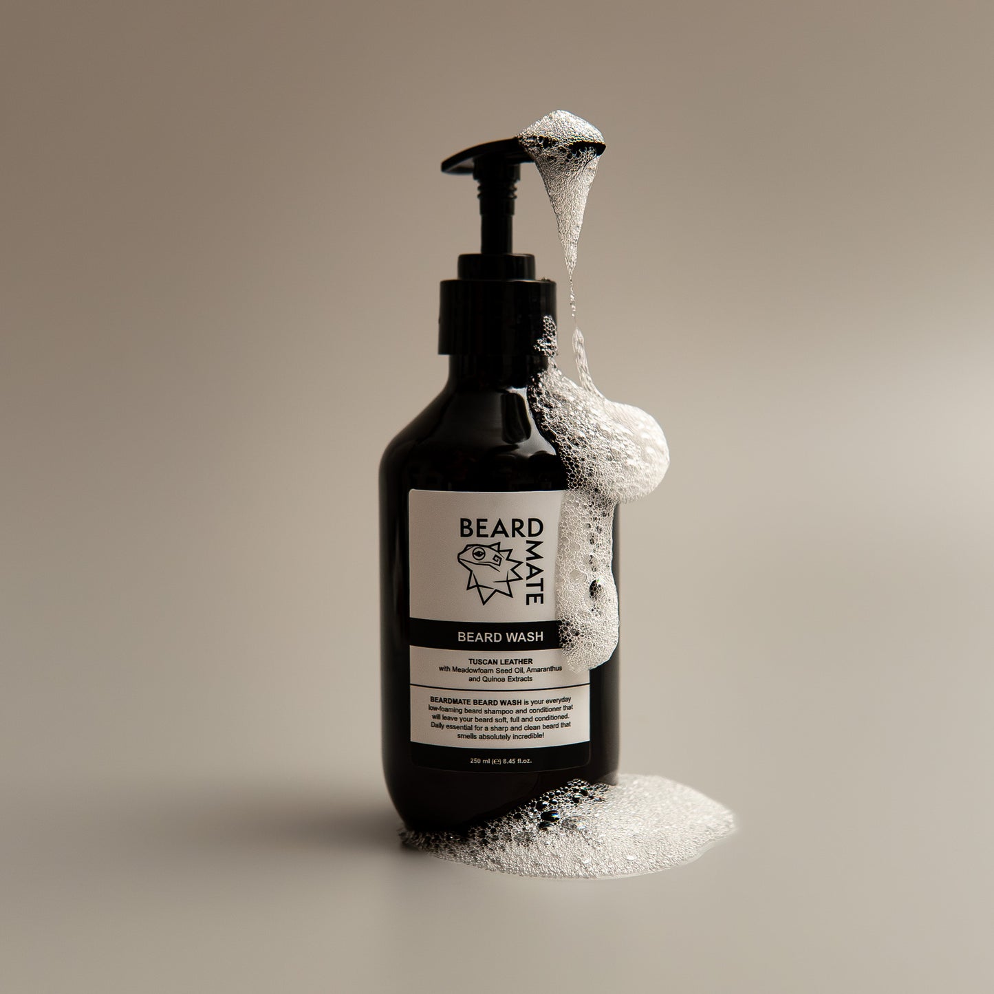 Black bottle of BEARDMATE beard wash with foam on a beige background