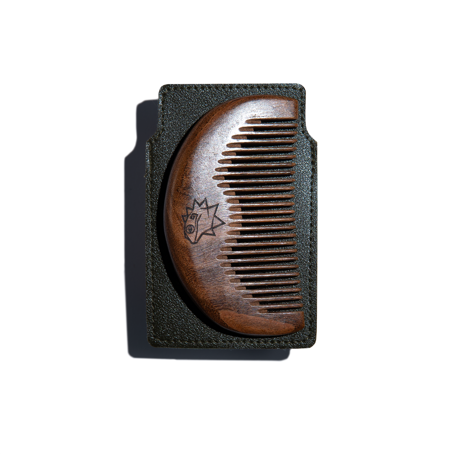 Wooden comb on a brown leather case on a white background