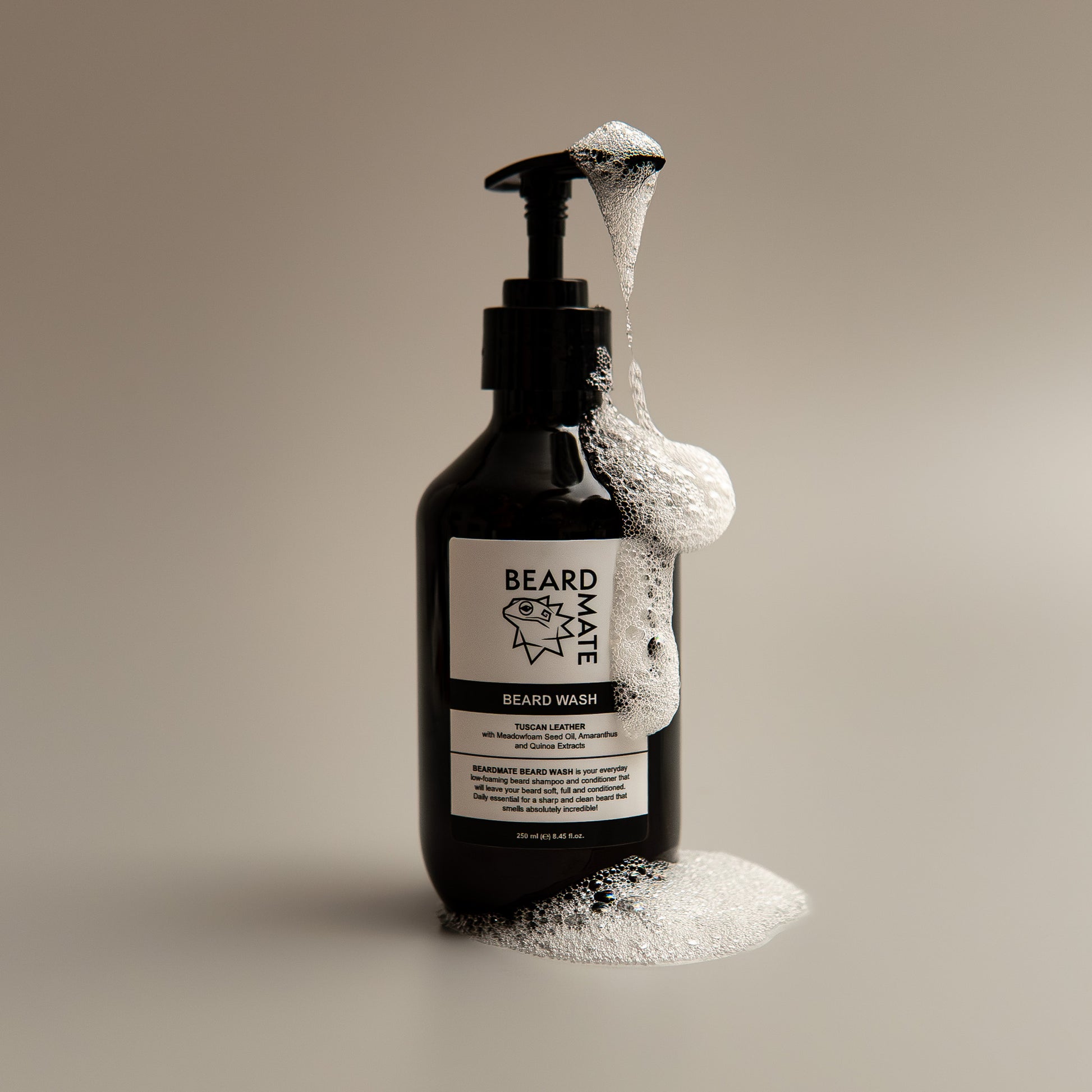 Black bottle of BEARDMATE beard wash with foam on a beige background