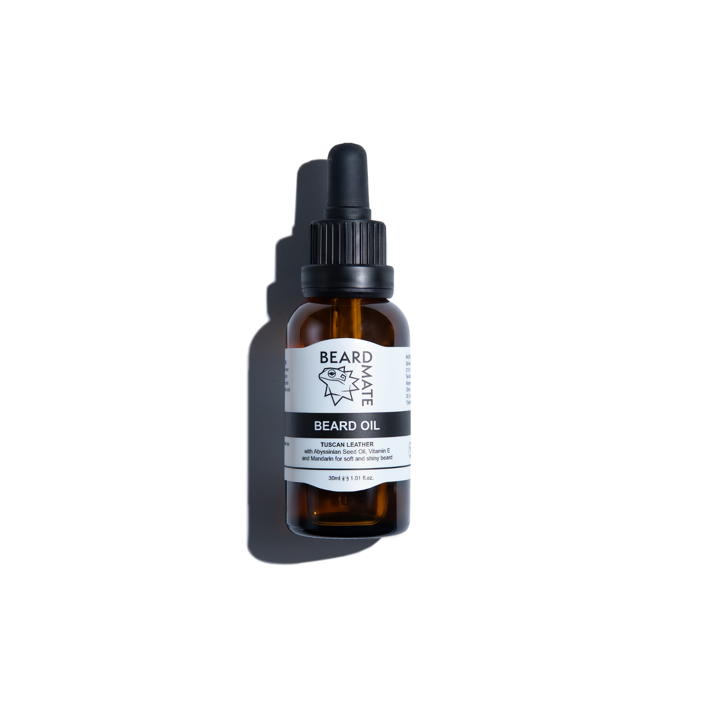 Brown glass bottle with beard oil and with black dropper labeled 'BEARDMATE' 
