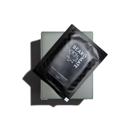 Black packaging of BEARDMATE beard cleaning wipes on a clear background