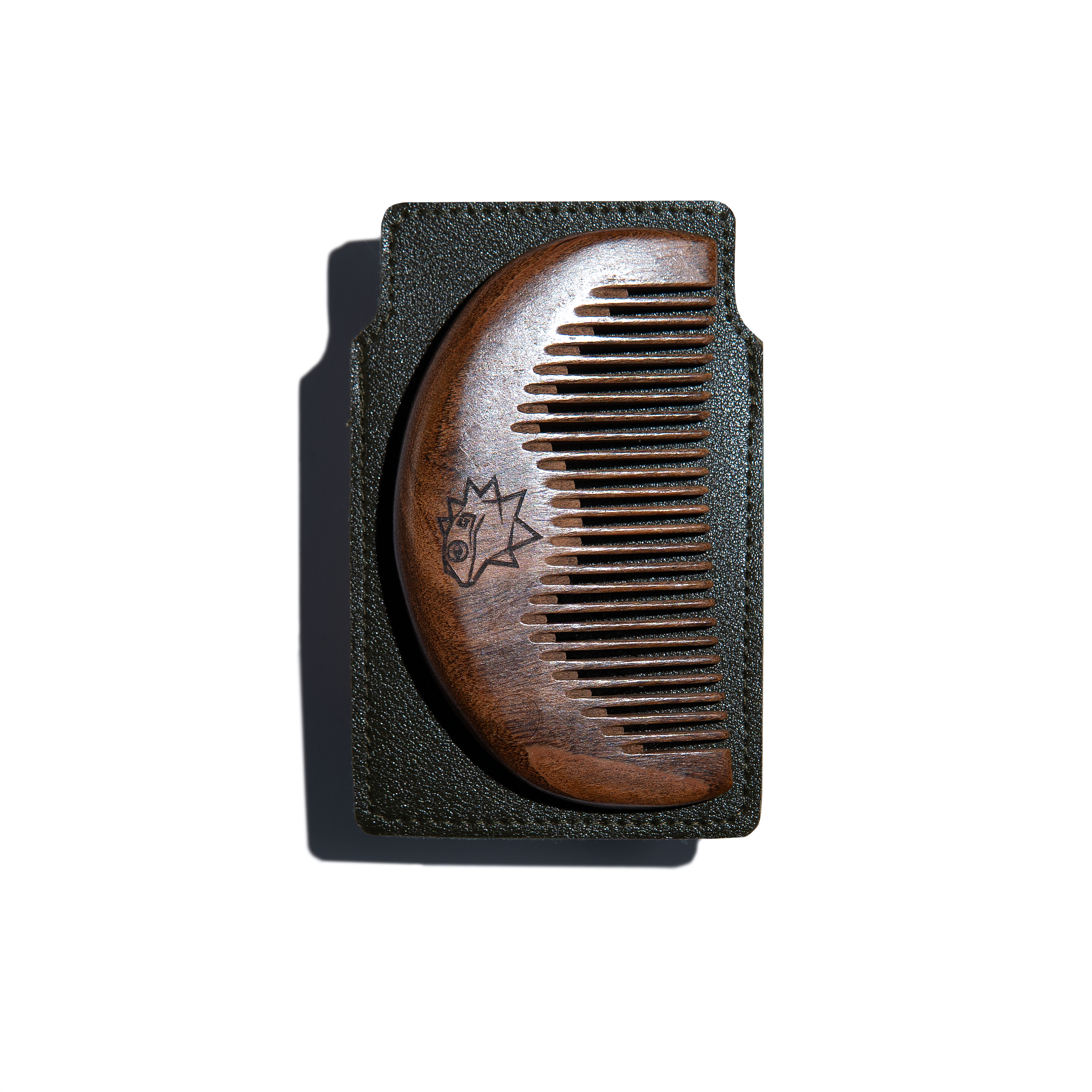 Wooden comb on a brown leather case on a white background
