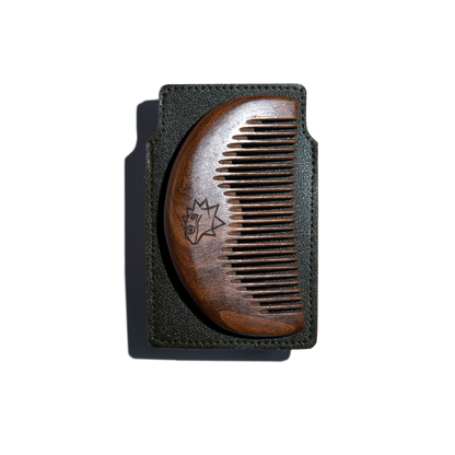 Wooden comb on a brown leather case on a white background