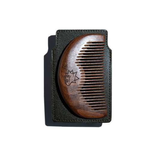 Wooden comb on a brown leather case on a white background