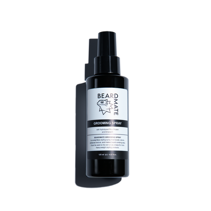 Black grooming spray bottle with a label on a white background