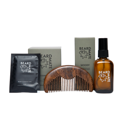 Beard care products including a bottle, comb, and packets on a white background