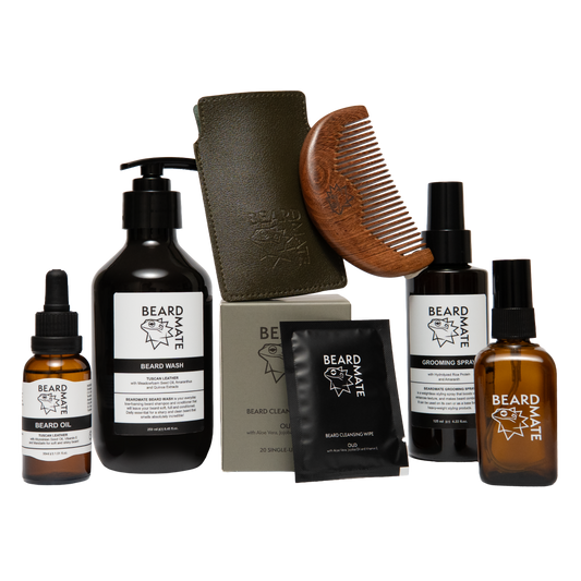 Collection of beard care products including bottles, boxes and a comb on a white background