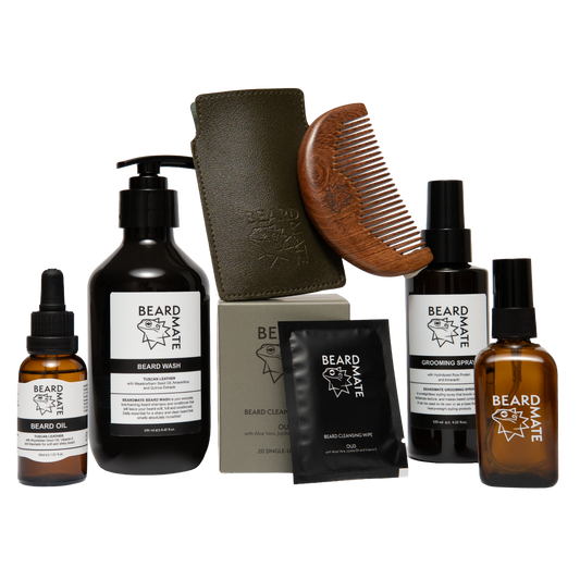 Collection of beard care products including bottles, a scrub, and a comb on a white background