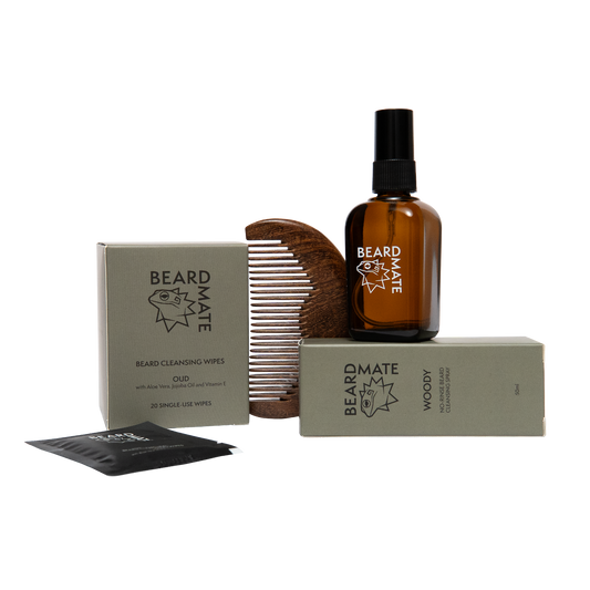 Beard care products including a bottle, comb, and packaging on a white background